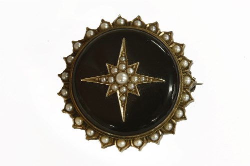 Lot 35 - A Victorian split pearl and black onyx circular brooch