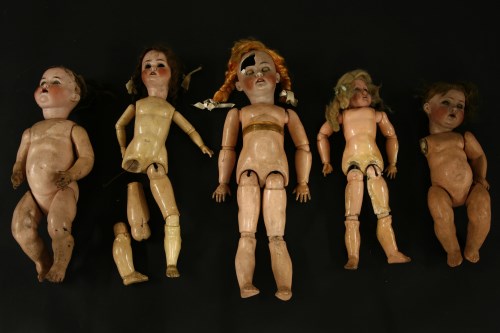 Lot 297 - Five bisque head dolls