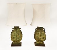 Lot 594 - A pair of bronze lamps