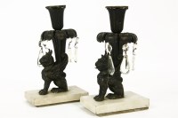 Lot 165 - A pair of French empire style candlesticks in the form of winged lions