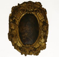 Lot 497 - A 17th century oil on carved panel of a woman punishing a cherub