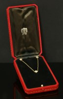 Lot 381 - A cased 18ct gold Cartier diamond set 'Inde Mystérieuse' pendant and earrings suite