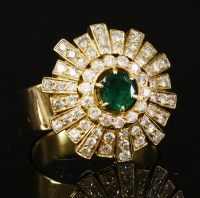 Lot 259 - An 18ct gold emerald and diamond sunburst cluster ring