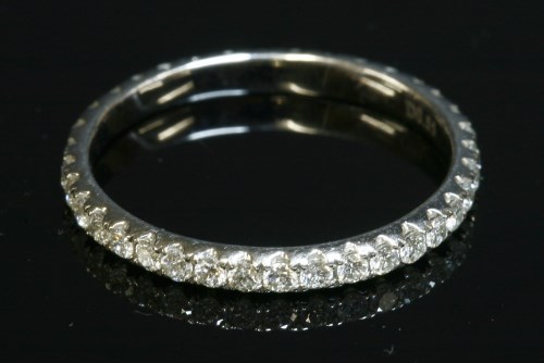 Lot 404 - A diamond set full eternity ring