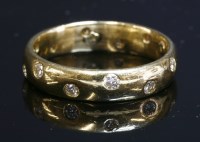 Lot 387 - An 18ct gold shallow court section diamond set wedding ring