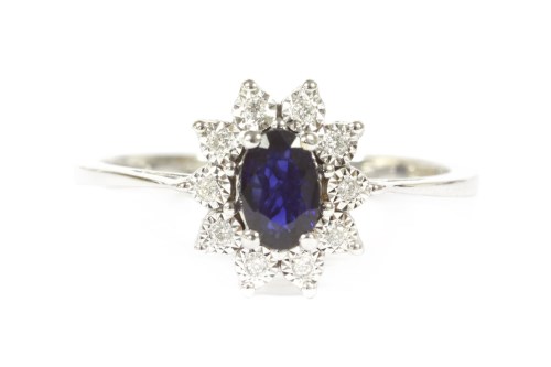 Lot 28 - An 18ct white gold sapphire and diamond oval cluster ring