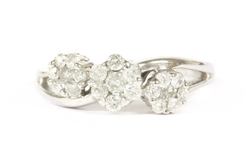 Lot 43 - A 9ct white gold triple cluster diamond crossover ring