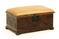 Lot 536 - A carved oak ottoman with pad seat together with a carved oak stool with hinged top (2)