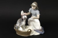 Lot 221 - A Lladro figural group of a girl giving her poorly dog medicine