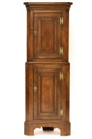 Lot 436 - A reproduction George III style oak floor standing corner cabinet