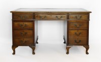 Lot 517 - An 18th century-style faded mahogany pedestal desk