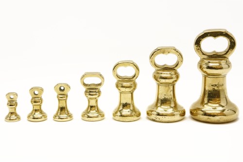 Lot 115 - A partial set of brass bell weights