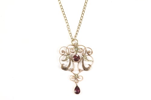Lot 36 - An Edwardian gold garnet and split pearl pendant