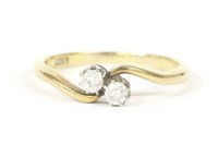 Lot 10 - A gold two stone diamond crossover ring