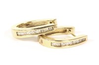Lot 21 - A pair of 9ct gold channel set brilliant cut diamond hinged earrings
4.60g