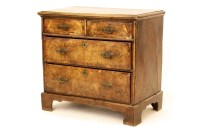 Lot 511 - An early 18th century walnut chest of four drawers