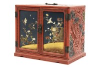 Lot 370 - A Japanese red and black lacquer cabinet