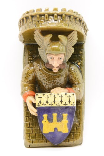 Lot 208 - French pottery wall bracket in the form of a knight supporting a rampart