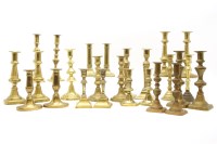 Lot 247 - Twenty-five Victorian brass candlesticks