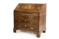 Lot 435 - A walnut and feather banded bureau