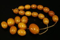 Lot 658 - A single row graduated olive shaped butterscotch amber bead necklace