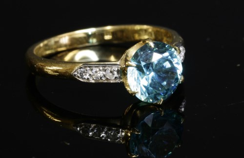 Lot 180 - An 18ct gold single stone blue zircon ring with diamond set shoulders by Cropp & Farr