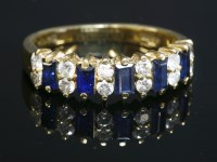 Lot 235 - An 18ct gold sapphire and diamond half hoop ring