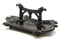 Lot 1002 - A Victorian cast iron and black painted boot scraper 42cm wide