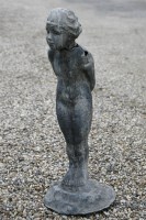 Lot 1018 - A lead figure of a boy standing on a rocky outcrop