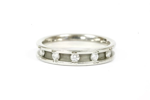 Lot 13 - A platinum five stone diamond half eternity ring
