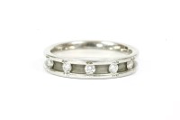 Lot 13 - A platinum five stone diamond half eternity ring