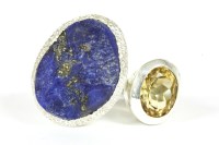 Lot 12 - A silver un-cut free form lapis lazuli ring and oval cut citrine ring
17.65g