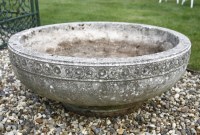 Lot 1045 - A circular cast stone planter on stand