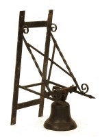 Lot 1121 - A bell on a wall mounted iron bracket