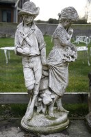 Lot 1059 - A composite stone figure of a boy and girl