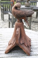 Lot 1073 - A terracotta dove roof tile ridge finial depicting a dove looking down
