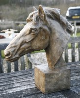 Lot 1085 - A cast stone sculpture of a horses head