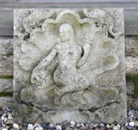 Lot 1089 - A cast stone weathered garden plaque of Venus within a shell