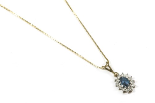Lot 57 - A 9ct gold blue topaz and diamond cluster pendant
