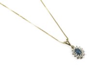 Lot 57 - A 9ct gold blue topaz and diamond cluster pendant