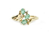 Lot 94 - A gold emerald and diamond spray cluster ring