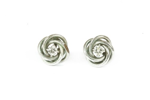 Lot 131 - A pair of 9ct white gold single stone diamond knot stud earrings