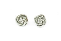 Lot 131 - A pair of 9ct white gold single stone diamond knot stud earrings