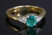 Lot 325 - A three stone emerald and diamond ring