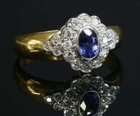 Lot 374 - An 18ct gold sapphire and diamond oval cluster ring