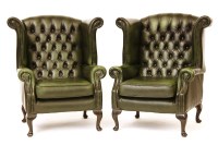 Lot 632 - A pair of green buttoned leather wing back club chairs