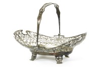 Lot 245 - A silver pierced basket with swing handle of ovoid form