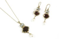Lot 69 - A 9ct gold garnet blue topaz and cultured freshwater pearl pendant and earring suite.  A circular oval mixed cut garnet claw set in a landscape position with a track cut blue topaz above and cultured