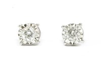Lot 115 - A pair of white gold single stone diamond stud earrings