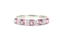 Lot 100 - A 9ct white gold pink sapphire and diamond half eternity ring